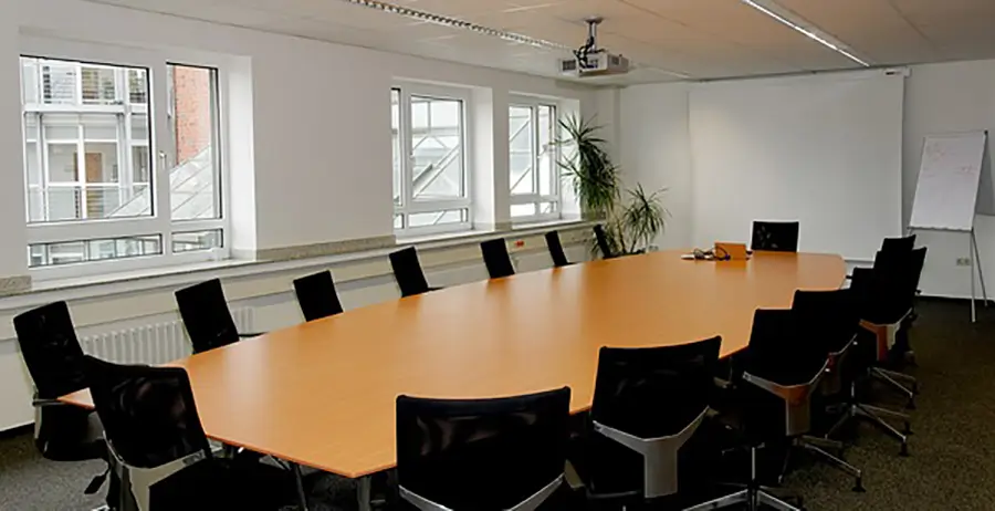 Conference room with table, projector, and office chairs