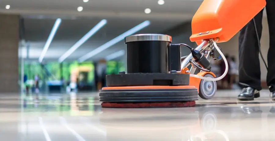 Floor buffing machine being used in office building lobby