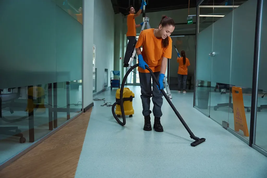 Team of janitors cleaning a modern professional office