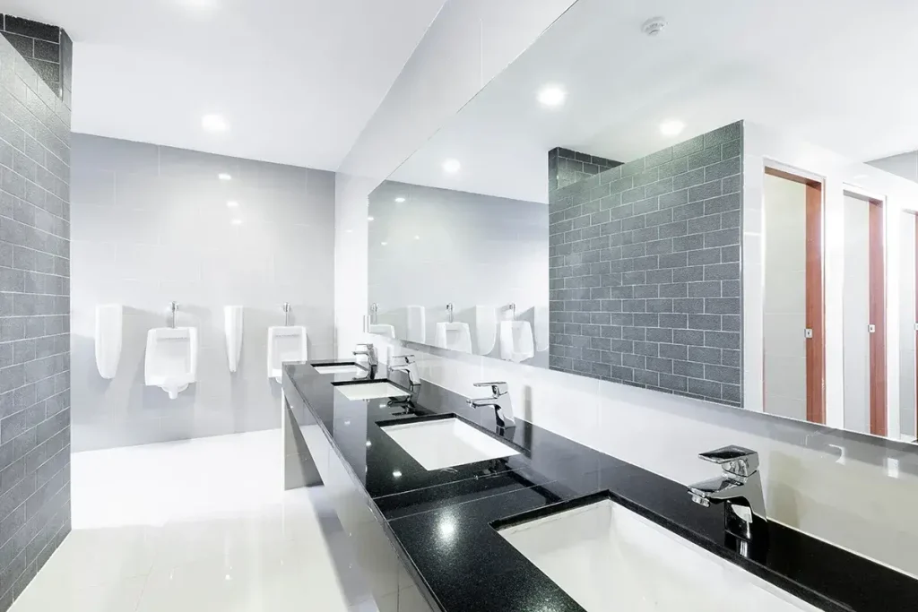Clean modern office bathroom with sinks and urinals