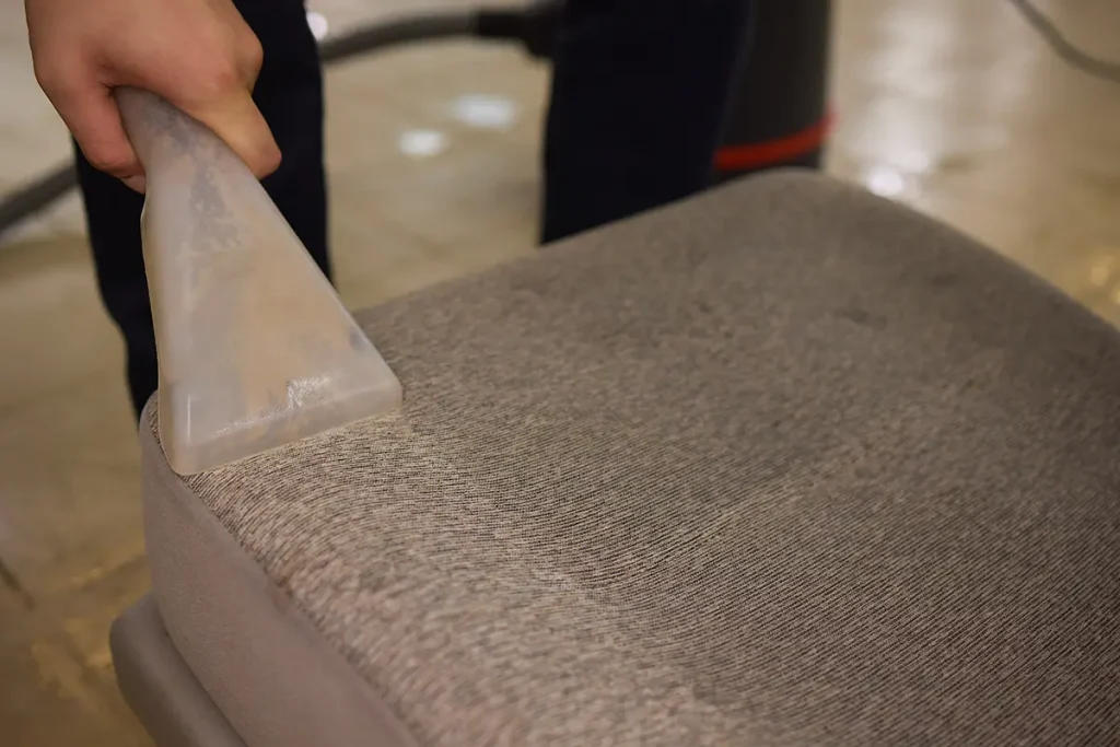 Office chair upholstery being cleaned with professional equipment.