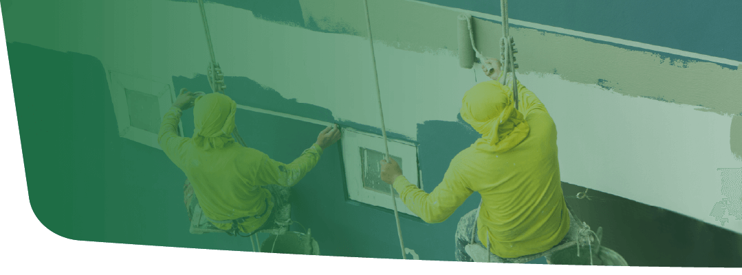 A pair of workers painting the walls the color blue.